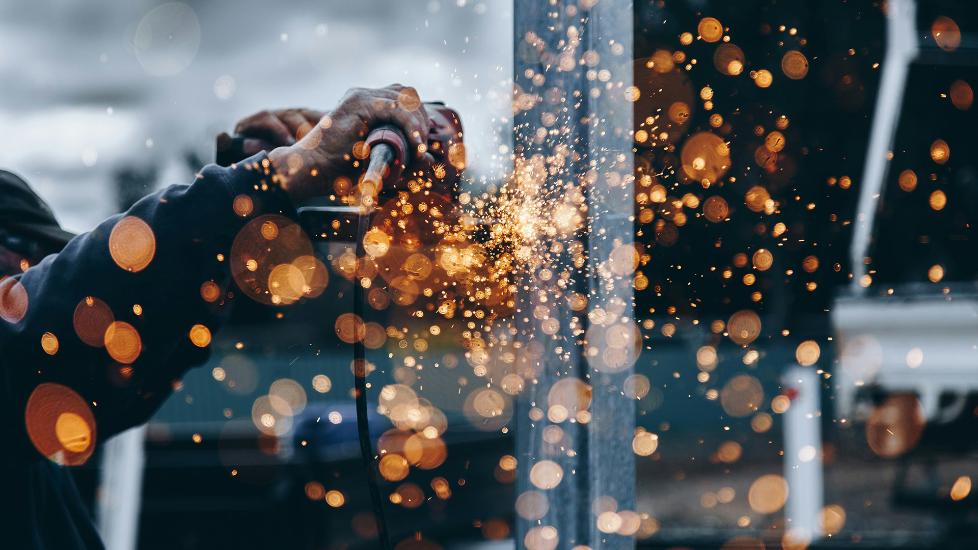 Simon Eggerstorfer grinds metal with an angle grinder